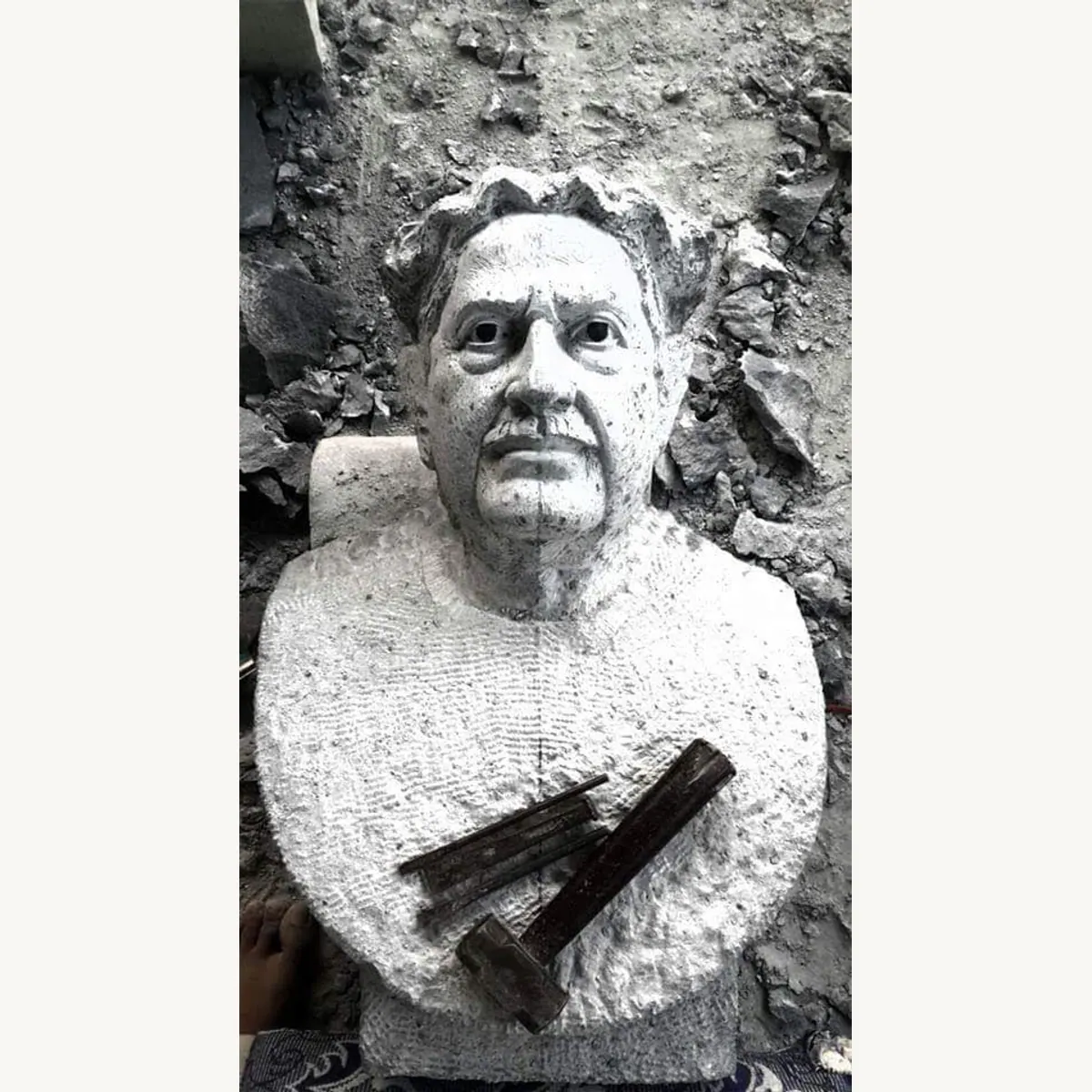 Textured stone portrait bust of Kannada writer Kuvempu in the carving workshop